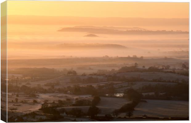Winter sunrise over the countryside. Canvas Print by David Wall