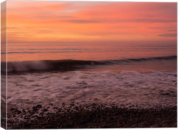 Sunset wave lapping the shoreline Canvas Print by Tony Twyman