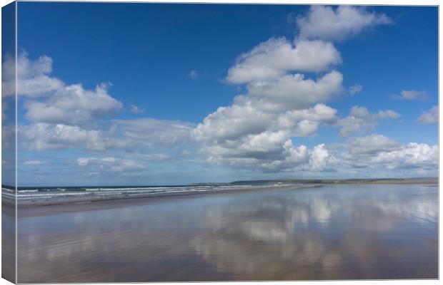 Clouds reflecting on a deserted Westward Ho beach Canvas Print by Tony Twyman