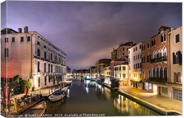 A canal water street with boats in Venice. Canvas Print by RUBEN RAMOS