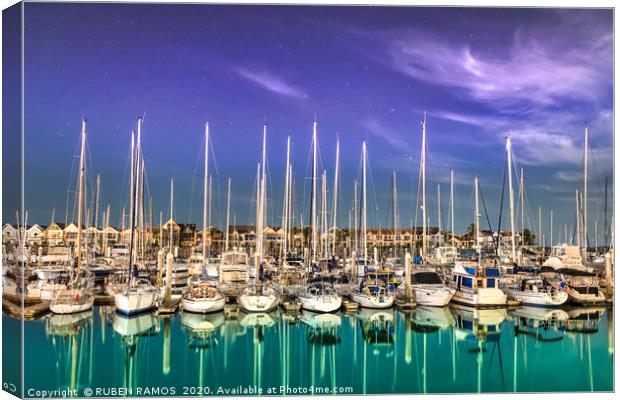 Sailboats moored on a peaceful bay at night. Canvas Print by RUBEN RAMOS