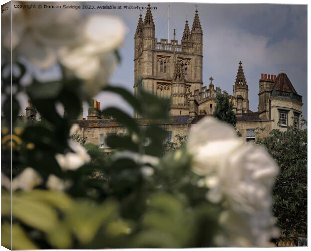 Bath Abbey framed by white roses Canvas Print by Duncan Savidge