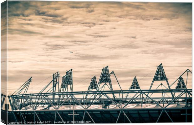 Airplane flying over the 2012 Olympic Stadium in Stratford, London, England, UK Canvas Print by Mehul Patel