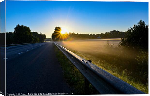 early sunrise over straight road with deminishing perspctive Canvas Print by Jonas Rönnbro