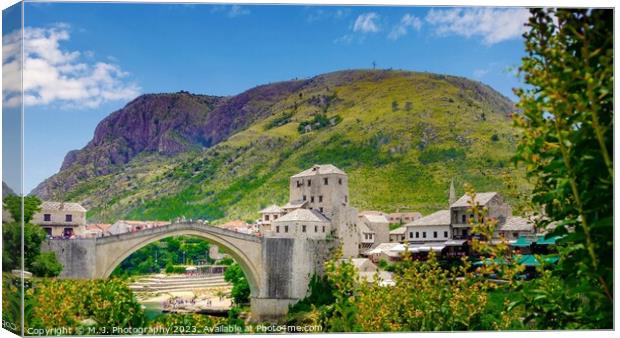 A bridge over a river in Mostar Canvas Print by M. J. Photography