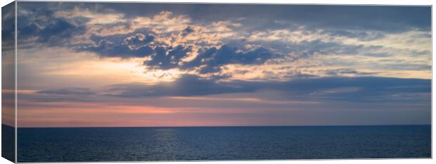 Colorful sky with clouds over the ocean Canvas Print by Wdnet Studio