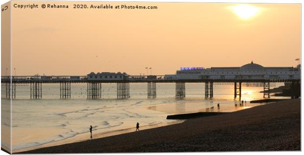 Sunset over Brighton pier Canvas Print by Rehanna Neky