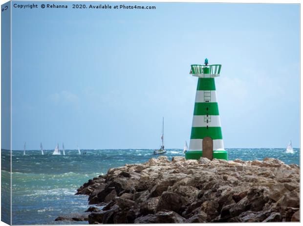 Sailboats speed past Vilamoura Lighthouse, Portuga Canvas Print by Rehanna Neky