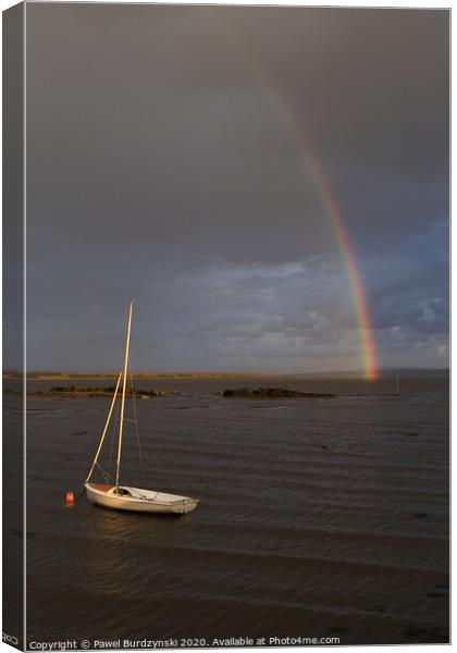 The rainbow over a boat Canvas Print by Pawel Burdzynski