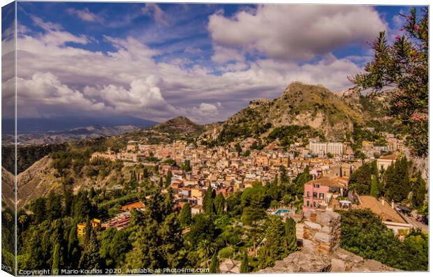 Panoramic view of the city of Taormina from its ancient Greek theater Canvas Print by Mario Koufios