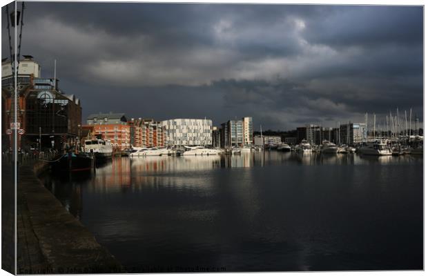 Ipswich waterfront marina with storm clouds Canvas Print by John Biglin