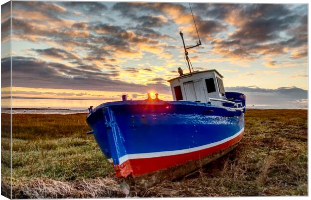 Fishing boat at sunset Canvas Print by Ian Homewood