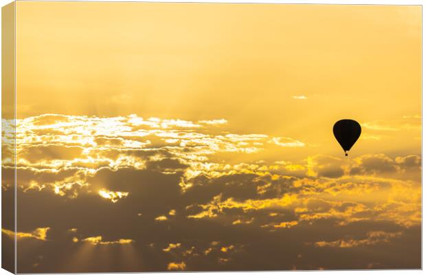 hot air balloon in the sky with orange sunrise clouds Canvas Print by David Galindo