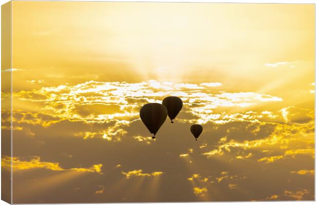 some hot air balloons in the sky with orange sunrise clouds Canvas Print by David Galindo