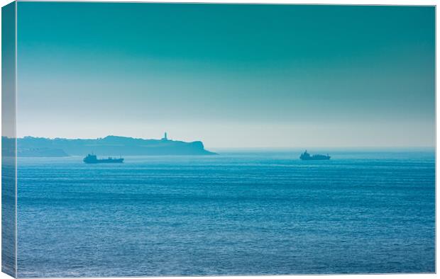 cargo ships with lighthouse in the background Canvas Print by David Galindo