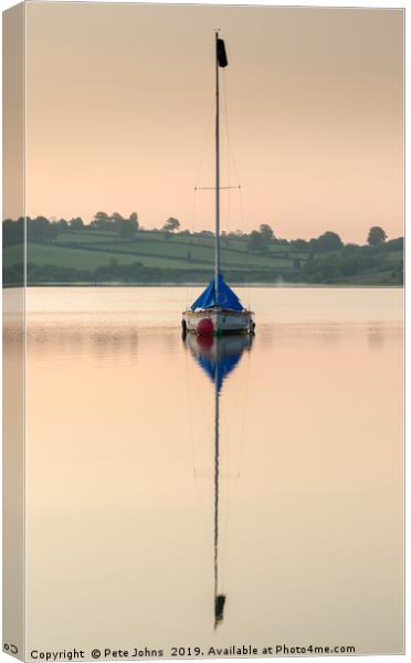 Boat reflecting on lake Canvas Print by Pete Johns