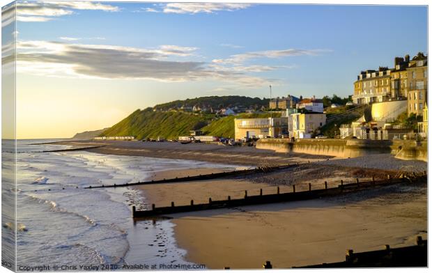 A view across Cromer beach at sunrise from the pier Canvas Print by Chris Yaxley