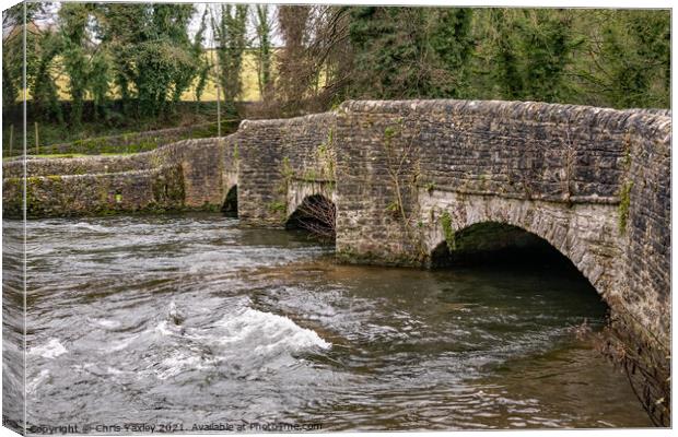 Sheepwash Bridge over a raging River Wye in Ashford in the Water, Derbyshire Canvas Print by Chris Yaxley