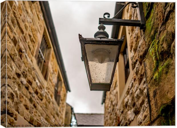 Victorian style light on an old and historic building in a narrow alley way Canvas Print by Chris Yaxley