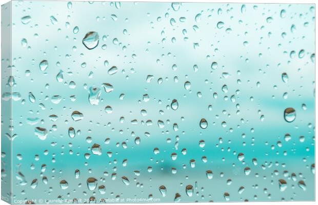Drops on a window glass with blurry blue background Canvas Print by Laurent Renault