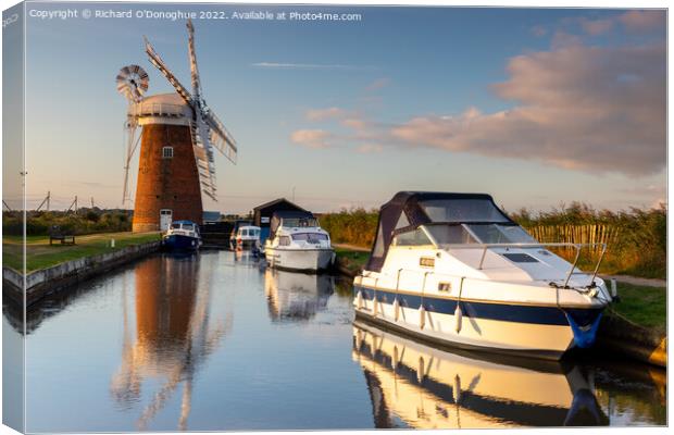 Boats moored at Horsey Mill on the Norfolk Broads at sunrise Canvas Print by Richard O'Donoghue
