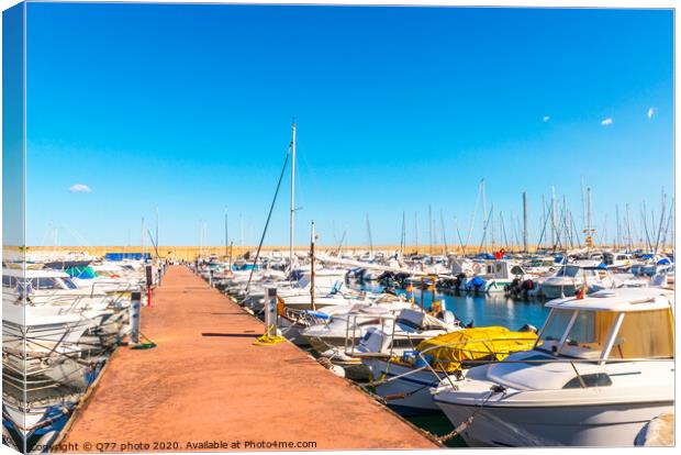 Beautiful luxury yachts and motor boats anchored in the harbor, hot summer day and blue water in the marina, blue sky Canvas Print by Q77 photo