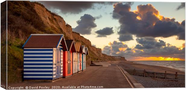 Cromer beach huts at sunset Canvas Print by David Powley