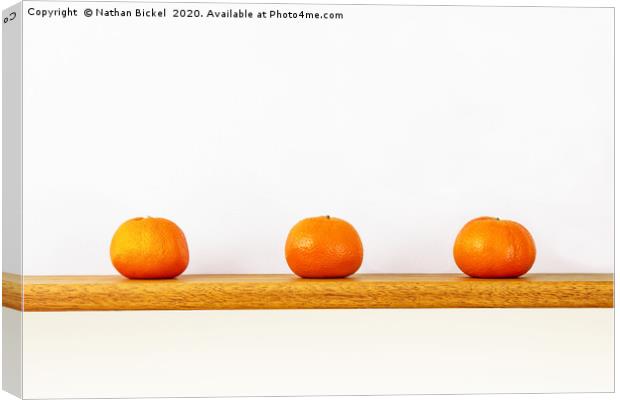 Three Oranges on a Shelf Canvas Print by Nathan Bickel