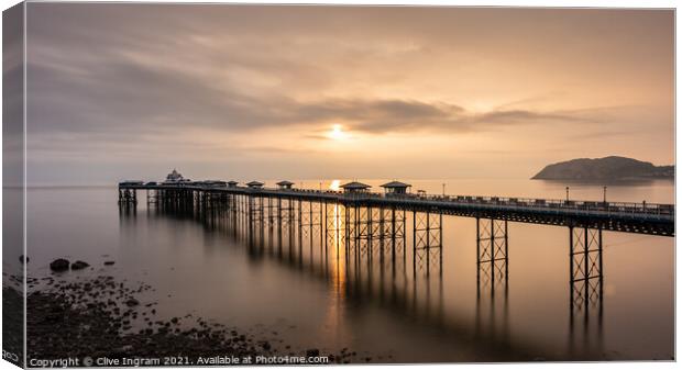 Pier at sunrise Canvas Print by Clive Ingram