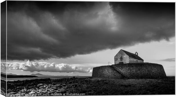 Moody Storm over St Cwyfans Canvas Print by Clive Ingram