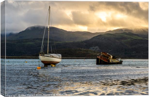 Boats at low tide under a winter's sun Canvas Print by Clive Ingram