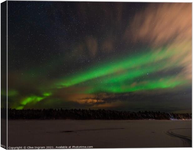 Aurora on a Finnish riverbank Canvas Print by Clive Ingram