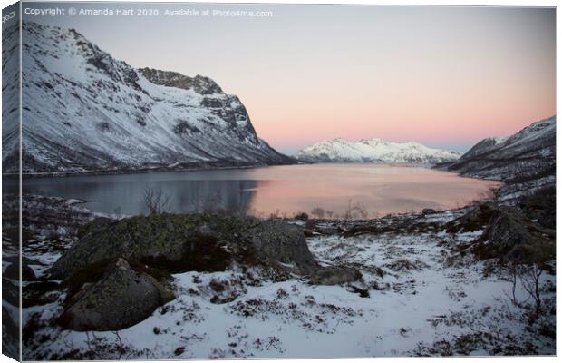 Winter sun over a fjord in Norway Canvas Print by Amanda Hart