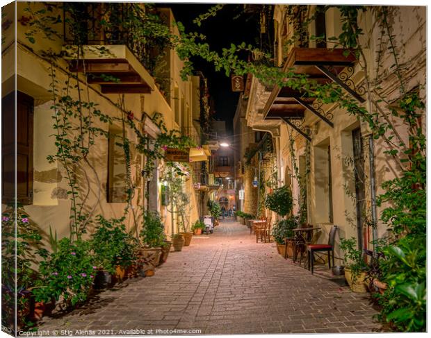 The illuminated narrow alley Antoniou Gampa with flowers and bal Canvas Print by Stig Alenäs