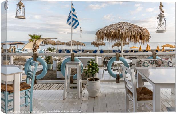 greek restaurant with blue and white tables right on the beach w Canvas Print by Stig Alenäs