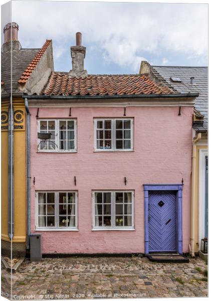 a small house in pink with a blue door on a cobble Canvas Print by Stig Alenäs