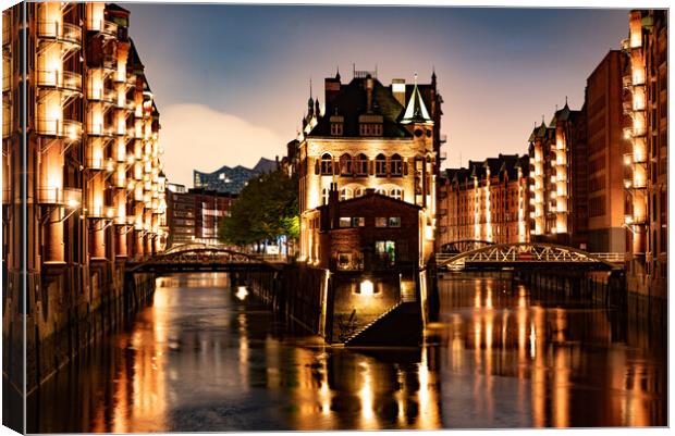 Historic warehouse district in the city of Hamburg by night - CITY OF HAMBURG, GERMANY - MAY 10, 2021 Canvas Print by Erik Lattwein