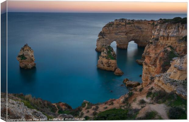 Natural arch cliffs of Praia da Marinha beach at sunset beautiful landscape with atlantic ocean, in Lagoa Portugal Canvas Print by Luis Pina