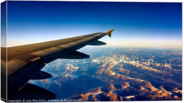 View from Airplane Window on a mountain landscape with snow and airplane wing Canvas Print by Luis Pina