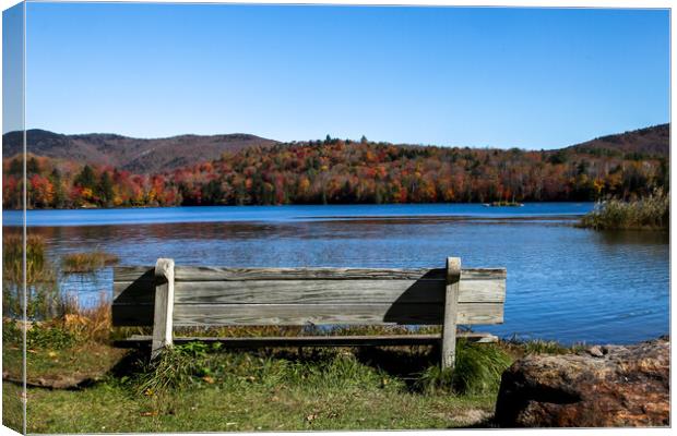 Wooden bench with colored autumn mountains Canvas Print by Miro V