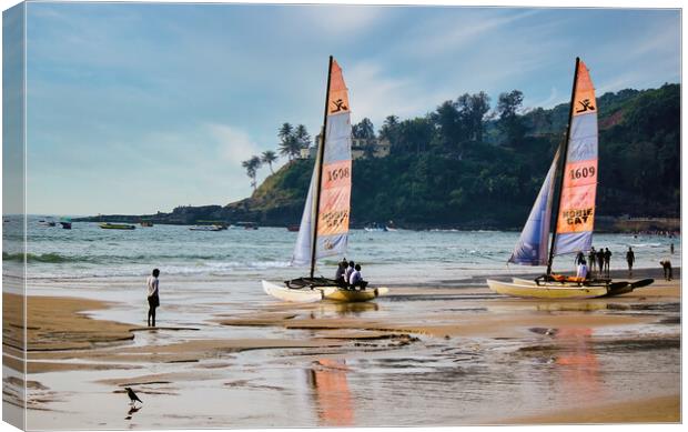Goa, India - October 25, 2018: Sailing boat kept on a seashore beach with it's reflection on water during evening. Commercial beach of Goa. Canvas Print by Arpan Bhatia
