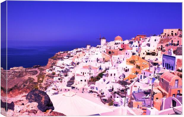 Santorini, Greece: Beautiful city of Oia ( Ia ) on a hill of white houses with blue roof and windmills against dramatic pink sky, located in Greek Cyclades islands in Mediterranean sea Canvas Print by Arpan Bhatia