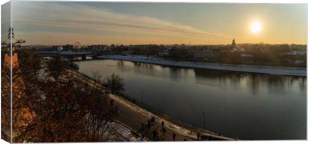 Krakow, Poland - January 31, 2021: Panorama aerial shot of Cracow cityscape next to Vistula river during sunset in Winter with people doing leisure. Canvas Print by Arpan Bhatia