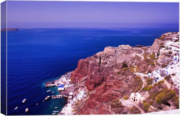 Imerovigli, Santorini, South Aegean, Greece. View to the clifftop village during daytime. Wide angle shot of houses on a volcanic mountain against blue mediterranean sea in Oia Canvas Print by Arpan Bhatia