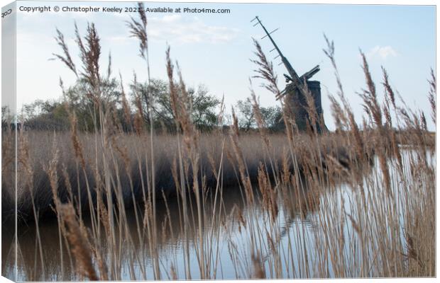 Brograve Mill through the reeds Canvas Print by Christopher Keeley