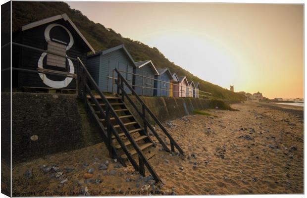 Sunset over Cromer beach huts Canvas Print by Christopher Keeley