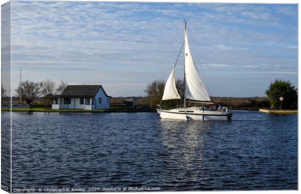 Sailing boat on the Norfolk Broads. Canvas Print by Christopher Keeley