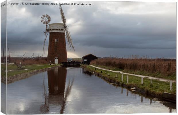 Cloudy skies over Horsey Mill Canvas Print by Christopher Keeley