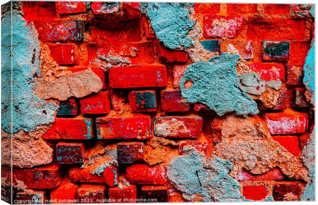 A damaged brick wall in digital red turquoise blue Canvas Print by Hanif Setiawan