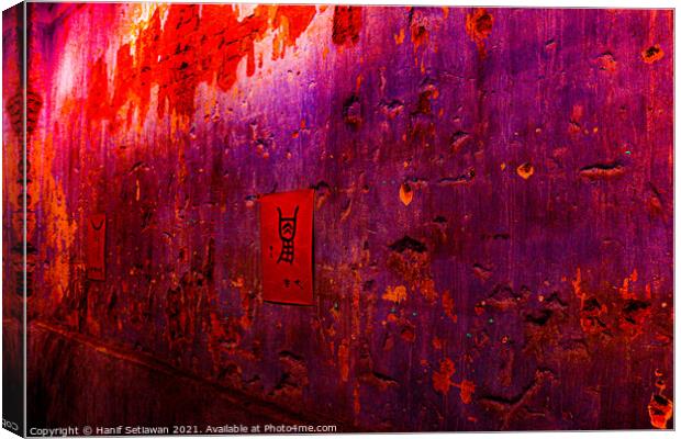 Small red poster with Chinese script on a violet wall. Canvas Print by Hanif Setiawan